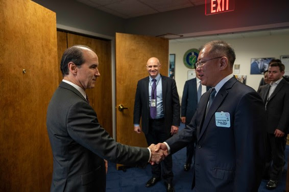 Under Secretary of Energy Mark Menezes and Hyundai Motor Group Executive Vice Chairman Euisun Chung shake hands