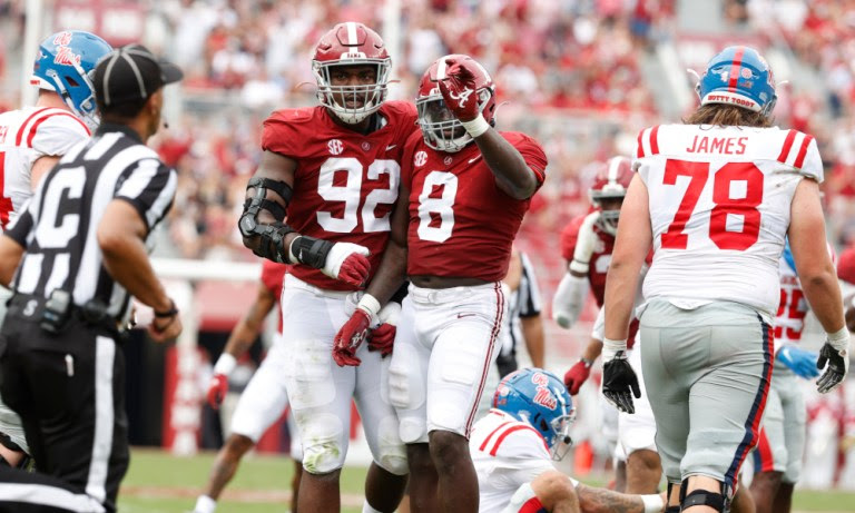 Christian Harris (#8) and Justin Eboigbe (#92) celebrates a stop for Alabama versus Ole Miss