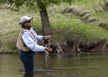 woman fly fishing in river