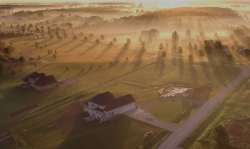 photo from the sky of a sunrise over a rural community