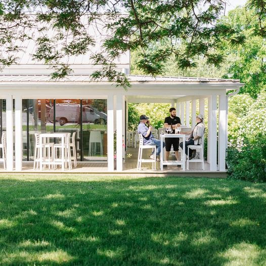 A group of people sitting at a table outside a house

Description automatically generated with medium confidence