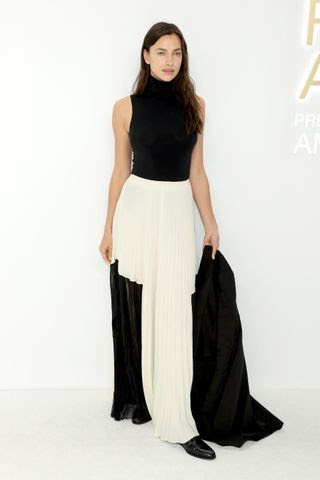 Image may contain Skirt Clothing Dress Irina Shayk Person Adult Footwear Shoe Blouse Formal Wear and Fashion