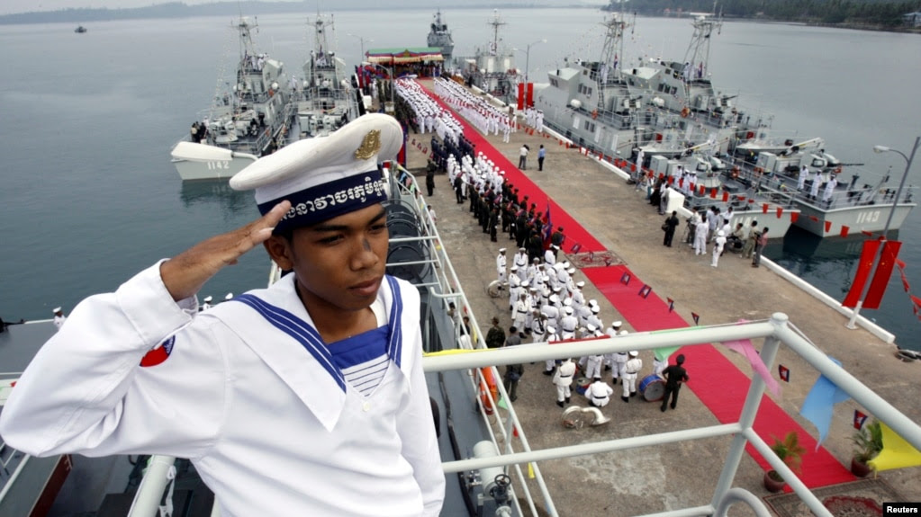FILE- A Cambodian navy sailor salutes on a Chinese naval patrol boat during a handover ceremony at a Cambodian naval base at Ream in Sihanoukville province, southwest of Phnom Penh, on November 7, 2007.