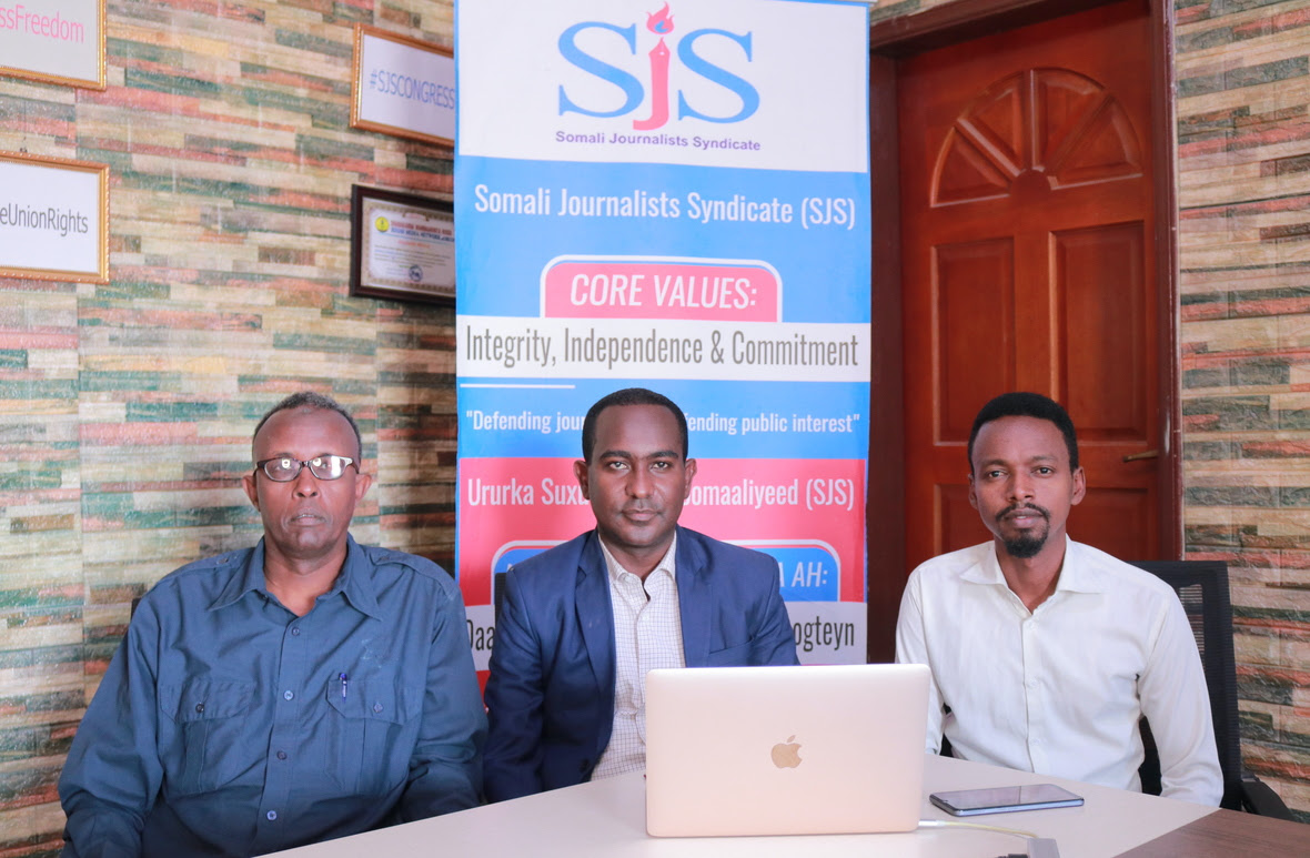 SJS Secretary General Abdalle Ahmed Mumin centre lawyer Abdirahman Hassan and SJS ExCom Member Hanad Ali Guled during a press conference in Mogadishu on Wednesday 9 February 2022.