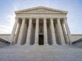 In this June 17, 2019, photo, The Supreme Court in Washington. A divided Supreme Court is allowing the Trump administration to put in place a policy connecting the use of public benefits with whether immigrants could become permanent residents. (AP Photo/J. Scott Applewhite) **FILE**