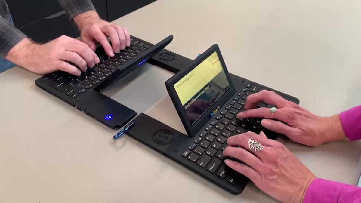 Two computers connected, allowing two people to type back and forth in real time. 