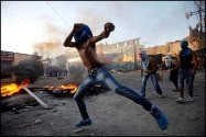 Masked Palestinians throw stones at Israeli security forces during clashes in the Shuafat refugee camp on the outskirts of Jerusalem.