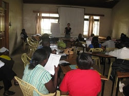 The figure above is a photograph showing a community meeting to discuss a Data Quality Improvement Plan.