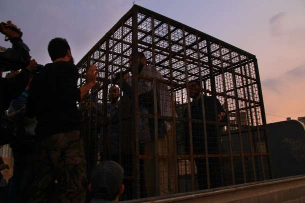 -- AFP PICTURES OF THE YEAR 2015 -- Syrians are seen inside a cage in Douma, the largest opposition stronghold on the outskirts of Damascus, on October 31, 2015, as it has been reported that a major Syrian rebel group is using dozens of captives in metal cages as