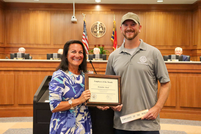 Image of Shanna Fullmer and Brandon Reed standing at the podium in the Board of Commissioners meeting room.