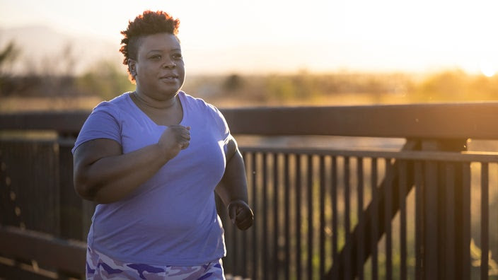 Woman on a run at golden hour.