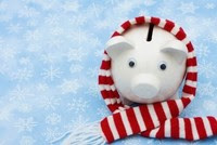 Piggy bank wrapped in a scarf against a snowy background
