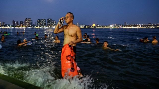 Pessoas nadam na interseção dos rios Han e Yangtze durante a onda de calor em Wuhan, província de Hubei, em 10 de agosto