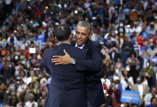U.S. President Barack Obama hugs Maryland Lt. Gov. Anthony Brown at a campaign rally for Brown at a High School in Upper Marlboro, Maryland October 19, 2014. REUTERS-Kevin Lamarque