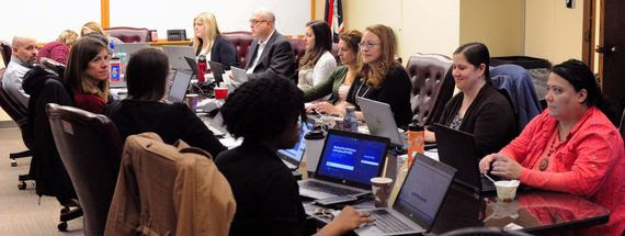 WDE staff sit with school district personnel and representatives from the statewide assessment vendor in a conference room working together to finalize details of the assessment to be given this spring.