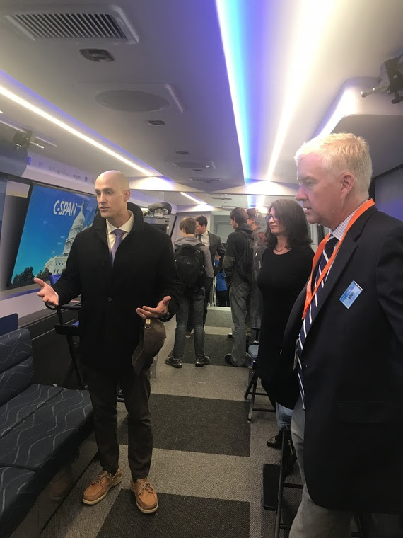 Dicky Shanor speaks with others inside the CSPAN bus during its stop in Cheyenne.