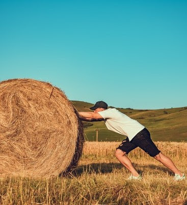Pushing a hay bale