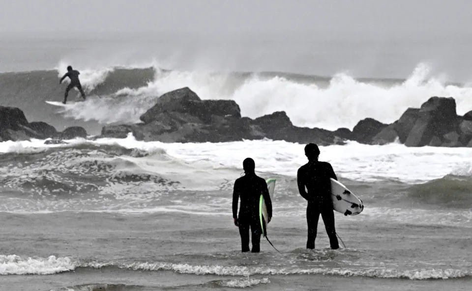 Surfers brave the waves during a rain storm at Venice Beach in Los Angeles on Saturday, Jan. 14, 2023. (Keith Birmingham/The Orange County Register via AP)