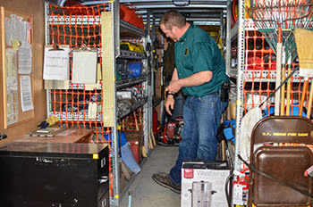 A DNR staffer inspects a fire supply trailer for readiness in Marquette.