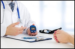 This is an image of a health care professional holding a blood glucose monitoring device.