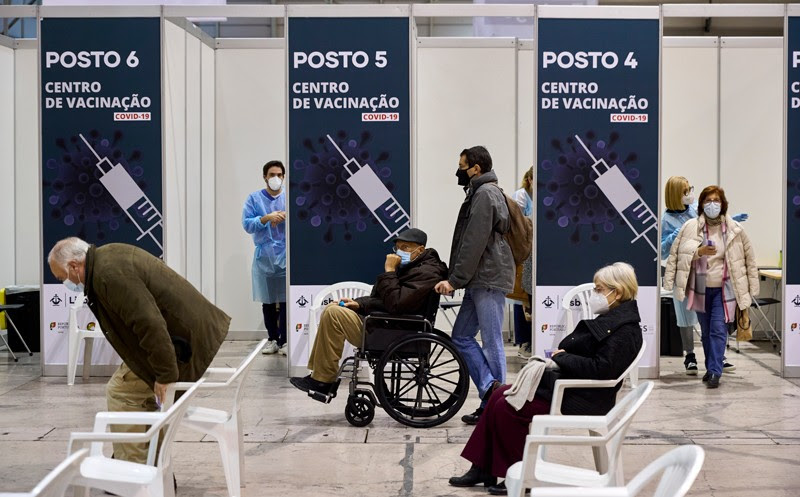 People wait to be inoculated at a vaccination centre