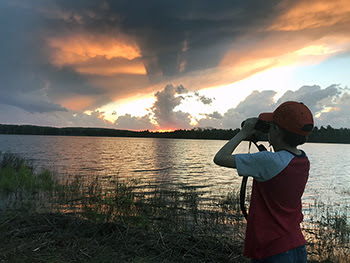 An image from Chad Stewart's family birdwatching album showing a young boy with binoculars.