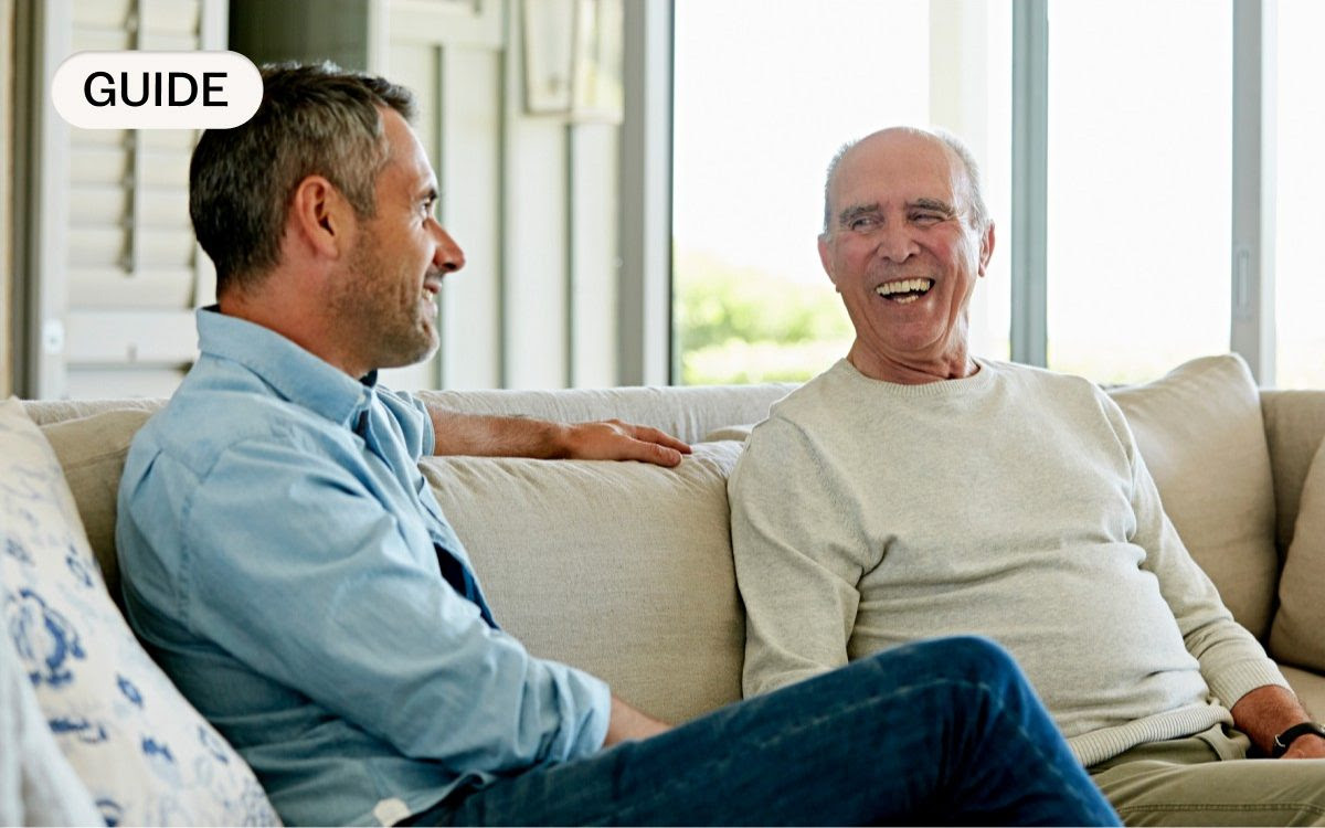 Two men sitting on a sofa in discussion