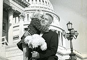Historical photo of Rep. John E. Fogarty hugging a young girl on the outdoor steps of the US capitol building