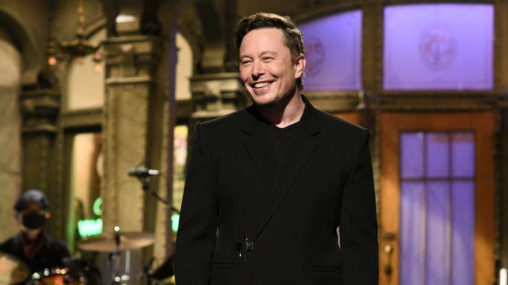 Elon Musk smiles as he hosts Saturday Night Live