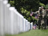 FILE -In this May 23, 2019 file photo, members of the 3rd U.S. Infantry Regiment, also known as The Old Guard, place flags in front of each headstone for &amp;quot;Flags-In&amp;quot; at Arlington National Cemetery in Arlington, Va. The Army is proposing new rules that would significantly restrict eligibility for burial at Arlington National Cemetery in an effort to preserve a dwindling number of gravesites well into the future. (AP Photo/Susan Walsh, File)