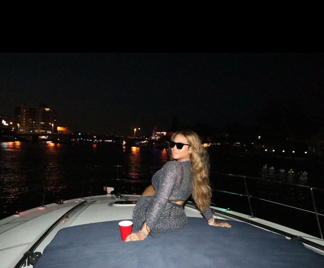 Beyonce flaunts curves in sheer gown with racy cut-outs and a plunging neckline as she lounges on a boat with close friends in Miami