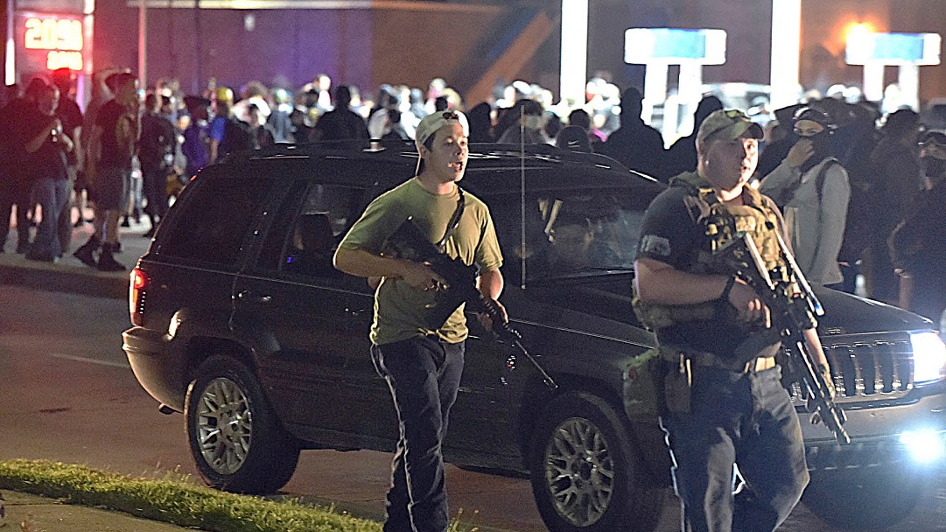 Rittenhouse walking with his gun past protesters Rittenhouse walking with his gun past protesters