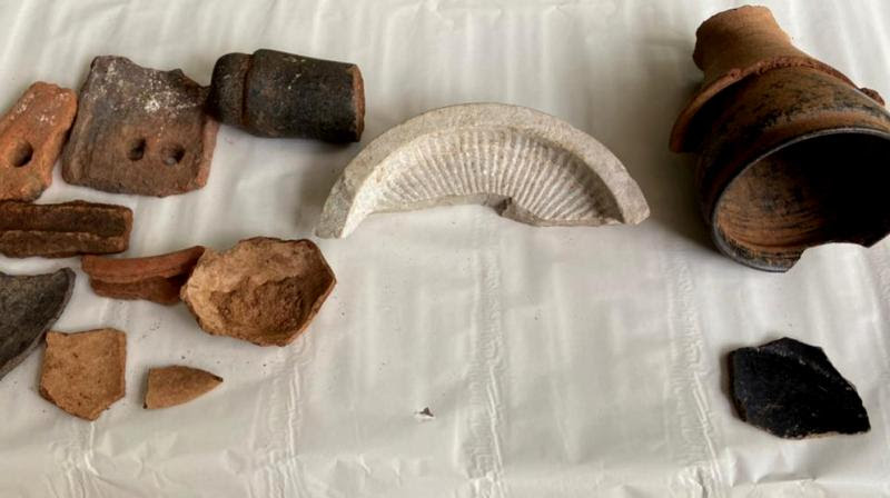 ivanagi Reddy has found a conical cup of polished ware inserted into a redware stand of Iron Age (1000 BC), pit shreds of redware, terracotta tiles that once covered roofs of Buddhist viharas, a well polished black granite muller, and a broken chatra (parasol) that enshrined a stupa of Satavahana period. (DC Image) ivanagi Reddy has found a conical cup of polished ware inserted into a redware stand of Iron Age (1000 BC), pit shreds of redware, terracotta tiles that once covered roofs of Buddhist viharas, a well polished black granite muller, and a broken chatra (parasol) that enshrined a stupa of Satavahana period. (DC Image)