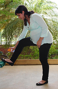 A pregnant woman applies mosquito repellant (CDC)