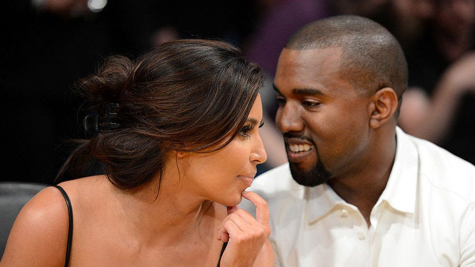 Kim Kardashian and rapper Kanye West talk from courtside seats in 2012