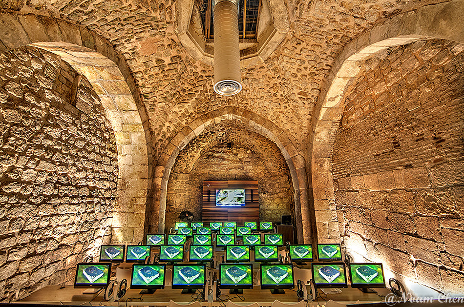 ancient underground hall full of modern computer screens