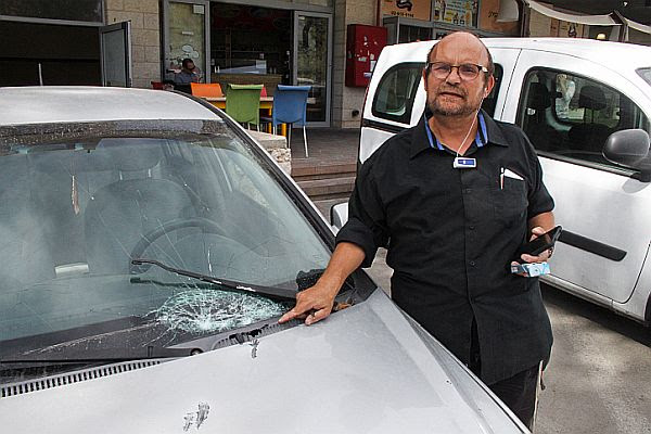 Israeli journalist Aharon Granot shows his smashed windshield, damaged in a stoning attack by Arab terrorists near the Judea city of Halhul, in Gush Etzion. (October 22, 2015)