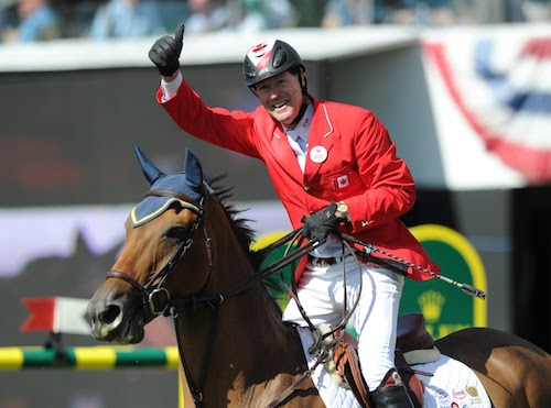Ian Millar acknowledges the huge crowd of spectators at Spruce Meadows.