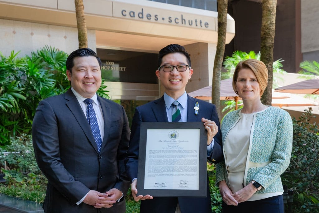 Hawai‘i State Senator Stanley Chang presents a certificate to Management Committee Members Amanda M. Jones and Nathan T. Okubo. | Photo: courtesy of Cades Schutte