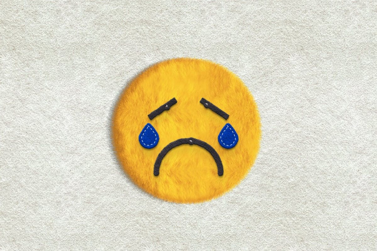 a sad face emoji made of faux fur