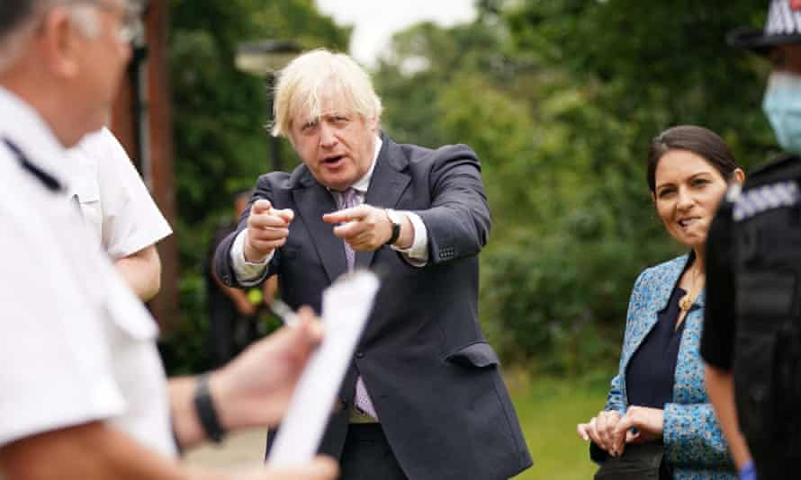 Boris Johnson (centre) with home secretary, Priti Patel, in Surrey as the government released new proposals to tackle crime.