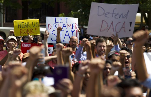 Protesters hold up signs during a rally supporting Deferred Action for Childhood Arrivals, or DACA, outside of the White House in Washington, on Tuesday, Sept. 5, 2017. President Donald Trump's administration will "wind down" a program protecting hundreds of thousands of young immigrants who were brought into the country illegally as children, Attorney General Jeff Sessions declared Tuesday, calling the Obama administration's program "an unconstitutional exercise of authority." ( AP Photo/Jose Luis Magana)