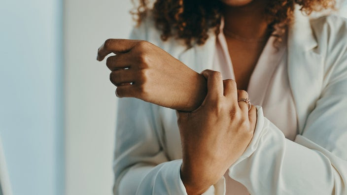 Cropped shot of someone holding their wrist in pain.