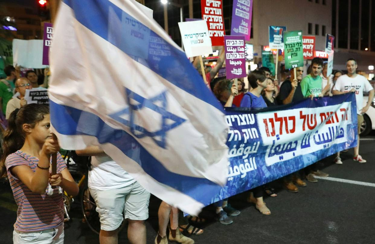 Demonstrators attend a rally to protest against the “Jewish Nation-State Bill” in Tel Aviv, July 14.