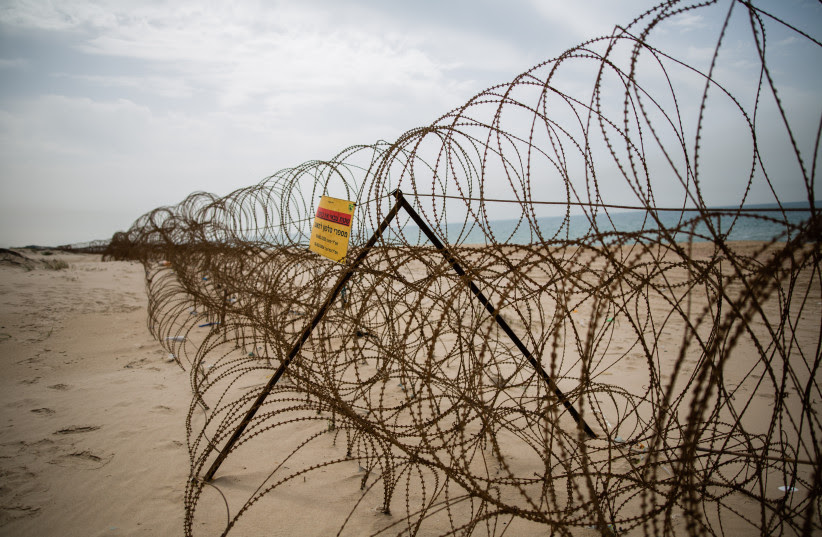 A barbed wire fence is seen on Zikim beach, in southern Israel near the border with Northern Gaza Strip, on April 5, 2016 (photo credit: CORINNA KERN/FLASH90)