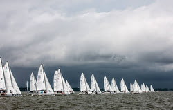 J/70s sailing before storm front