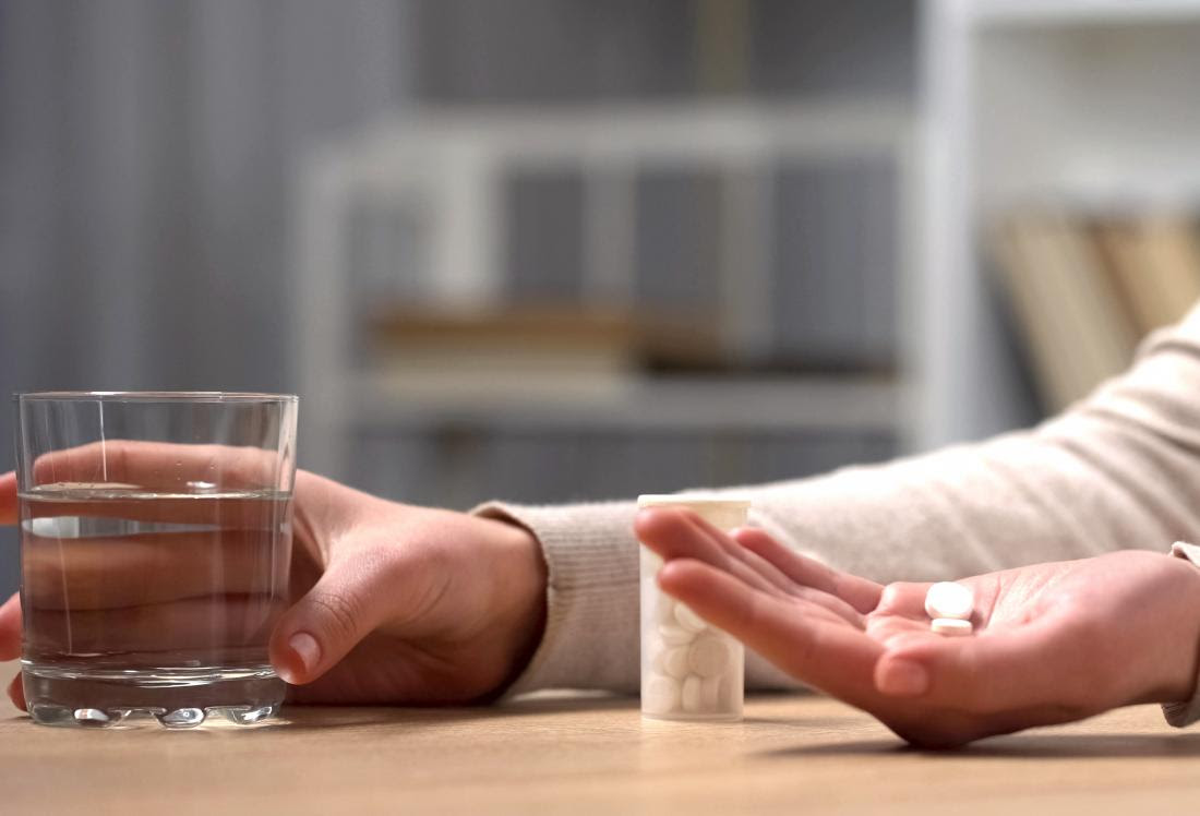 woman holding pill in hand and wondering can you overdose on antidepressants