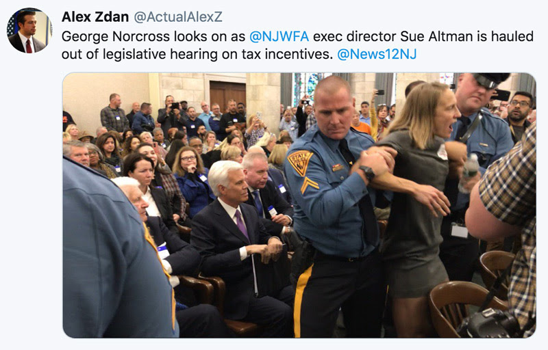 George Norcross looks on as NJWFA Director Sue Altman is hauled out of legislative hearing