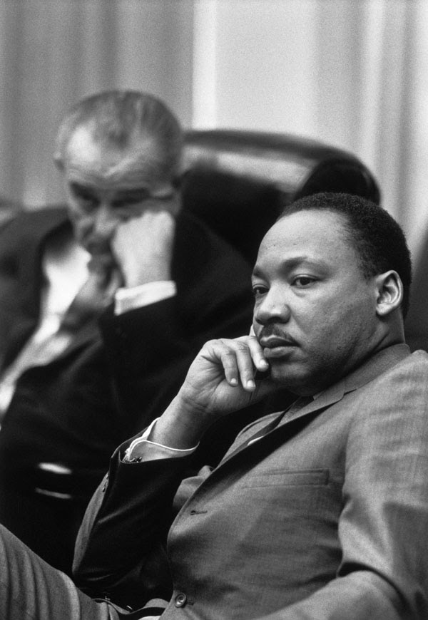 "Rev. Martin Luther King, Jr.; Presiden Lyndon Johnson in background."