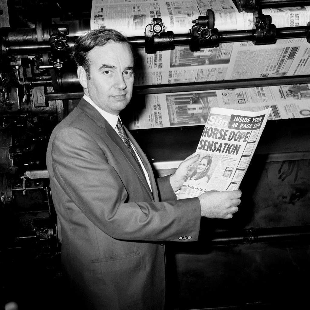 e picture, dated 17/11/1969, Rupert Murdoch looks at one of the first copies of The Sun newspaper, at the News of the World building , in London.